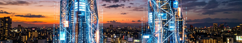 Two tall skyscrapers with digital data patterns glowing on their surfaces at dusk in a cityscape